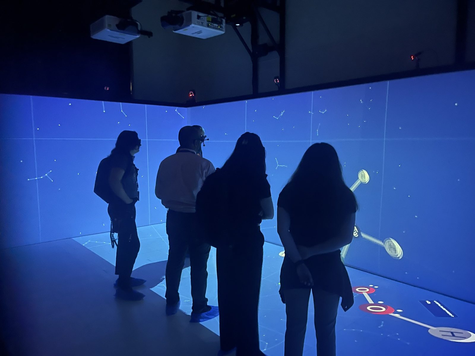 Visitors in 3D glasses inside Southern University's CAVE room