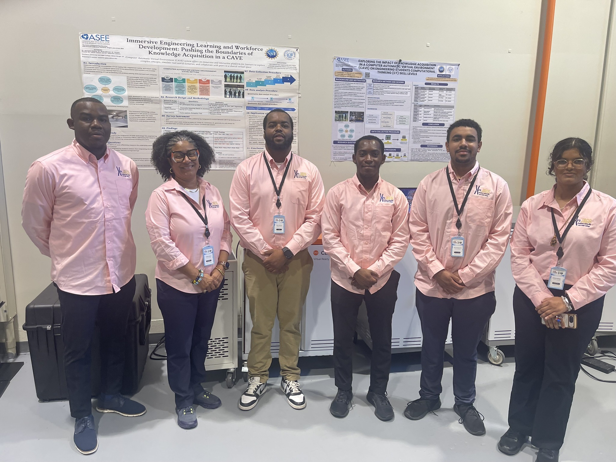 Six members of the XR JAGS student team in front of the CAVE research posters